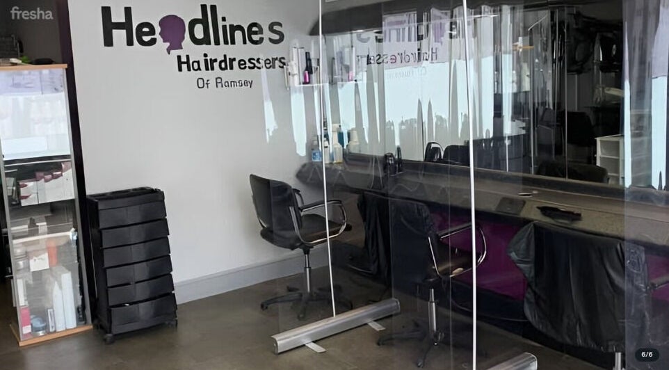 Chic salon interior at The Hair Project, Ramsey, England, GB featuring stylish chairs and mirrors.