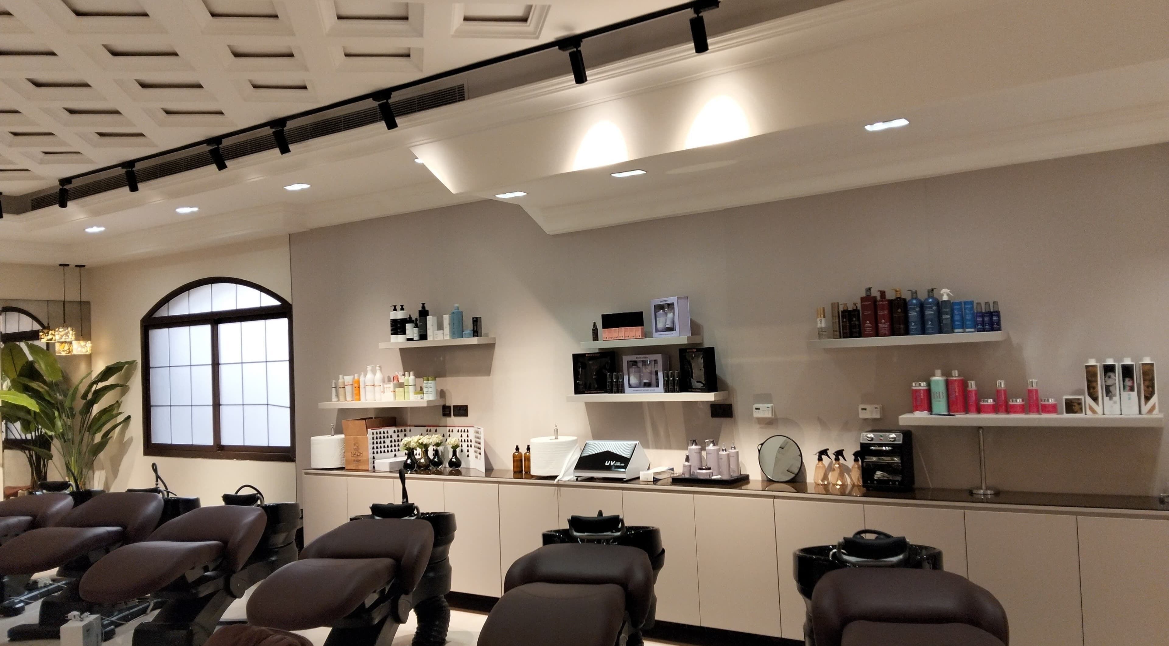 Interior of Solo Beauty Center in Al Ain, Abu Dhabi, AE with modern spa chairs and premium products on display.