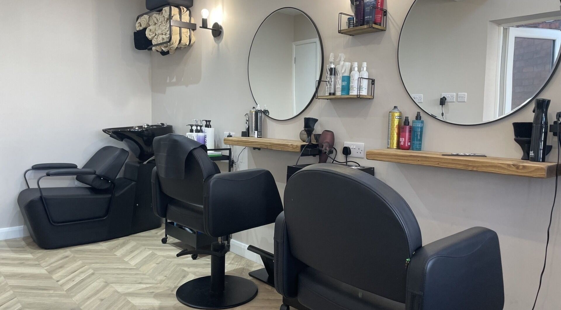 Chic salon interior with styling stations at Elle @ Studio Twenty One, Rugby, England, GB.