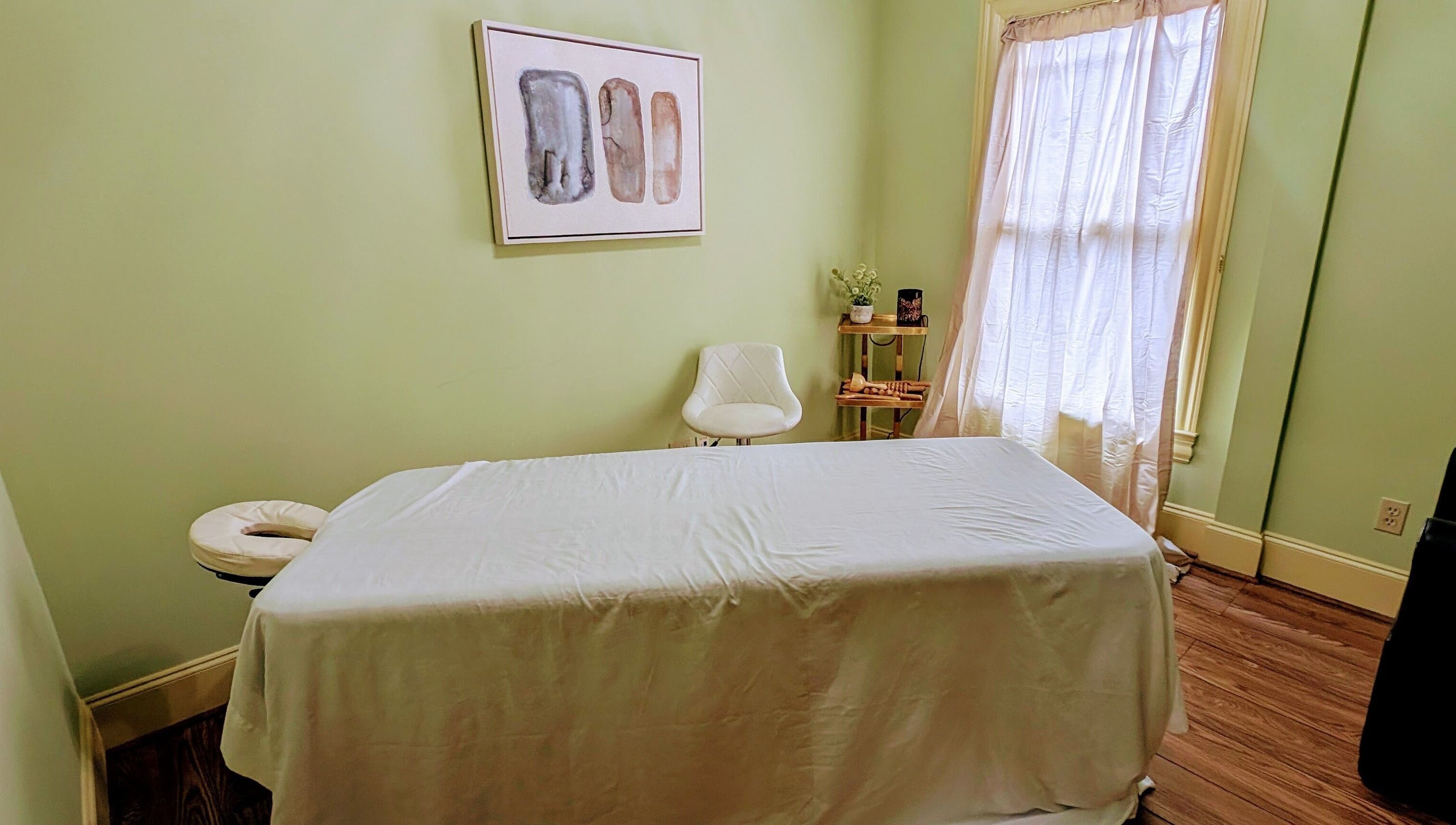 Peaceful massage room at Devine Creations in Stockbridge, Georgia, US with a massage table and serene decor.