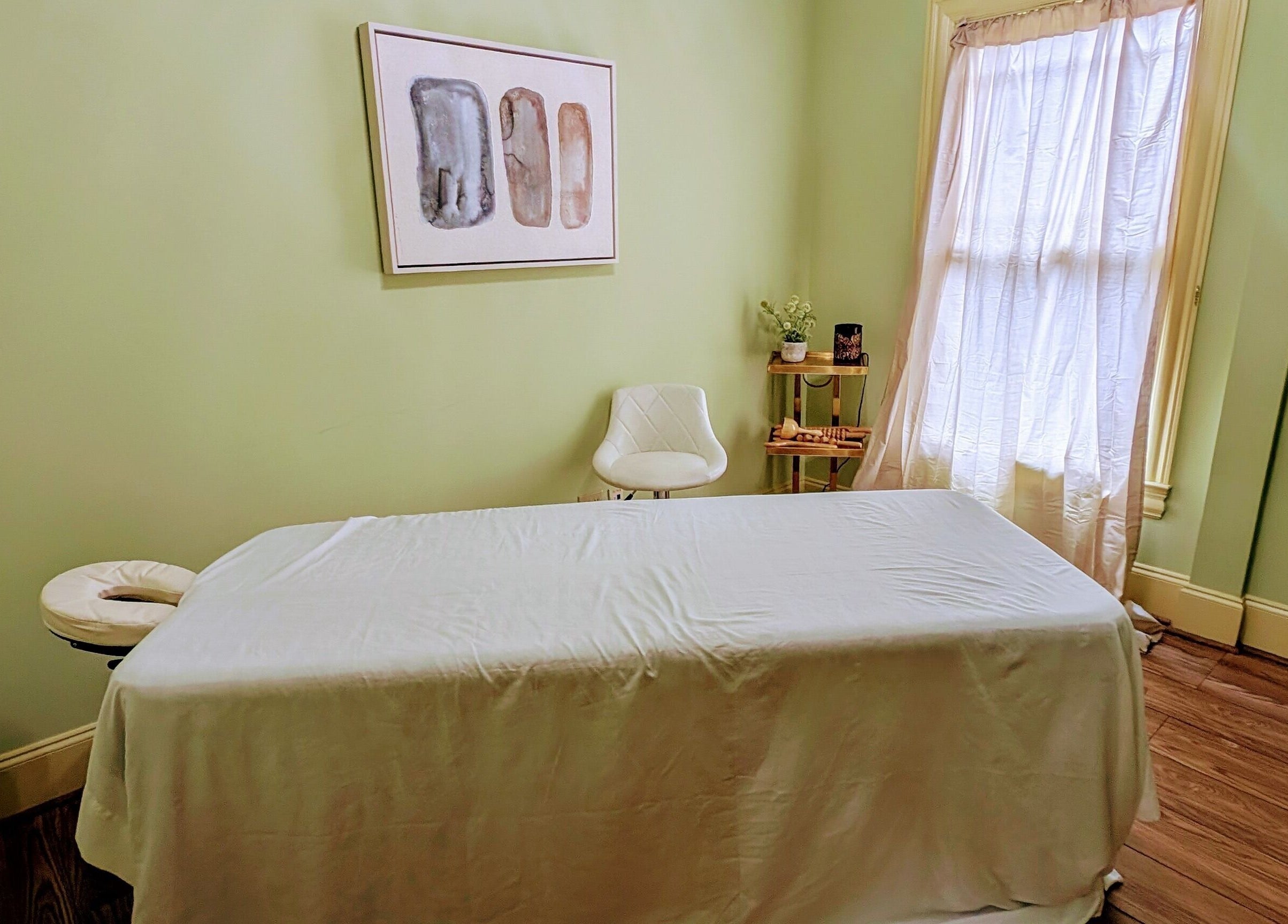 Peaceful massage room at Devine Creations in Stockbridge, Georgia, US with a massage table and serene decor.