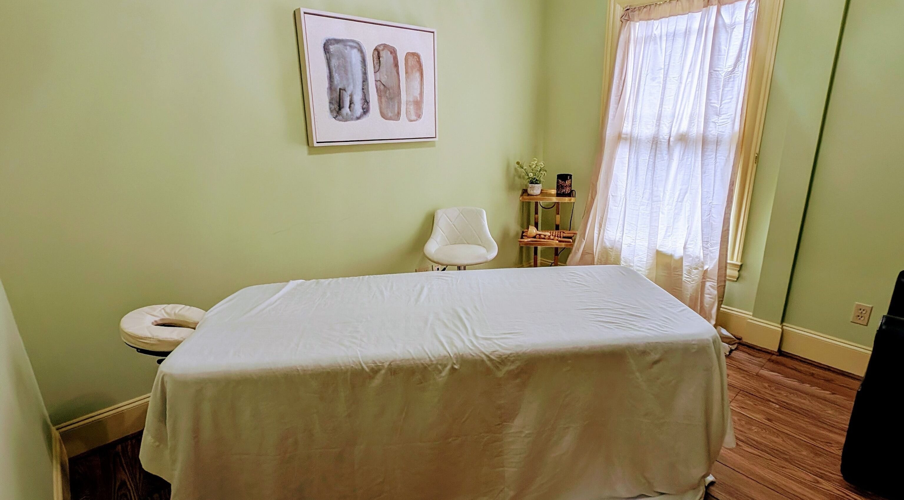 Peaceful massage room at Devine Creations in Stockbridge, Georgia, US with a massage table and serene decor.