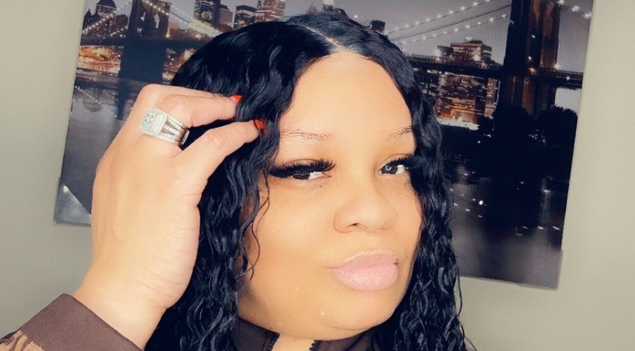 Close-up of a stylish woman with curls at IvyBeautyBar2, Darien, Illinois, US, showcasing elegant beauty.