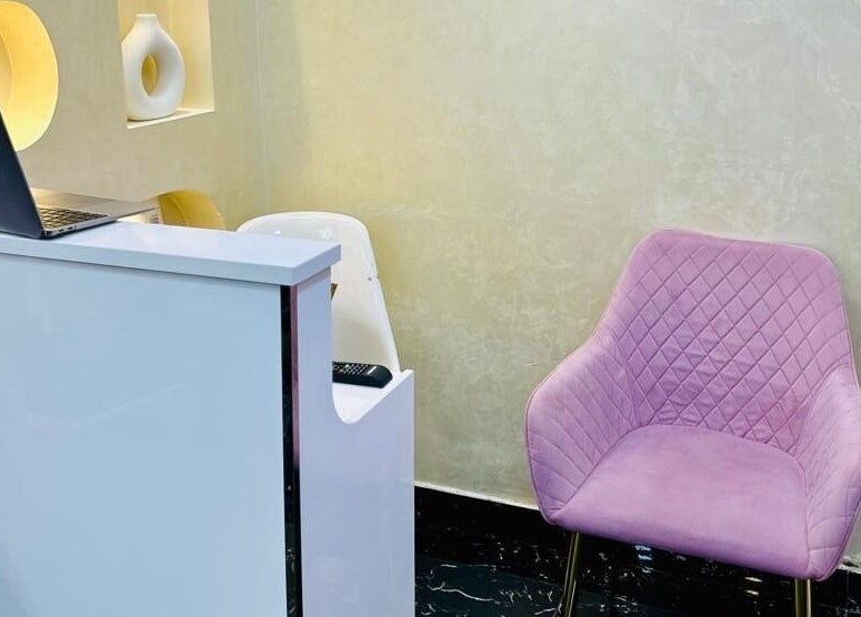 Reception with pink chair at Samiha Alsarraj Ladies Salon in Sharjah, Sharjah, AE, showcasing modern style.