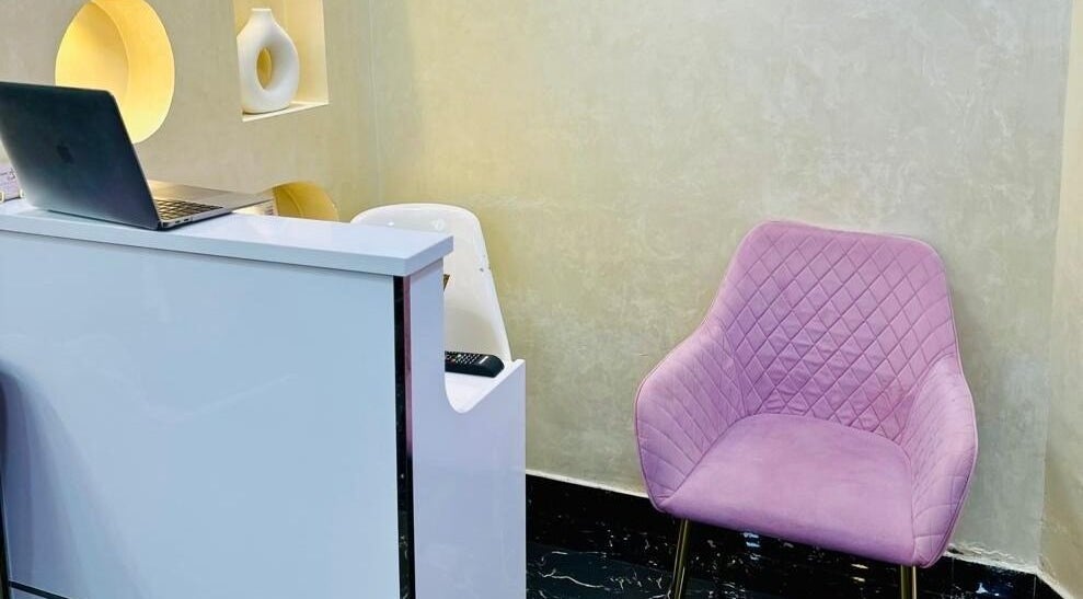 Reception with pink chair at Samiha Alsarraj Ladies Salon in Sharjah, Sharjah, AE, showcasing modern style.