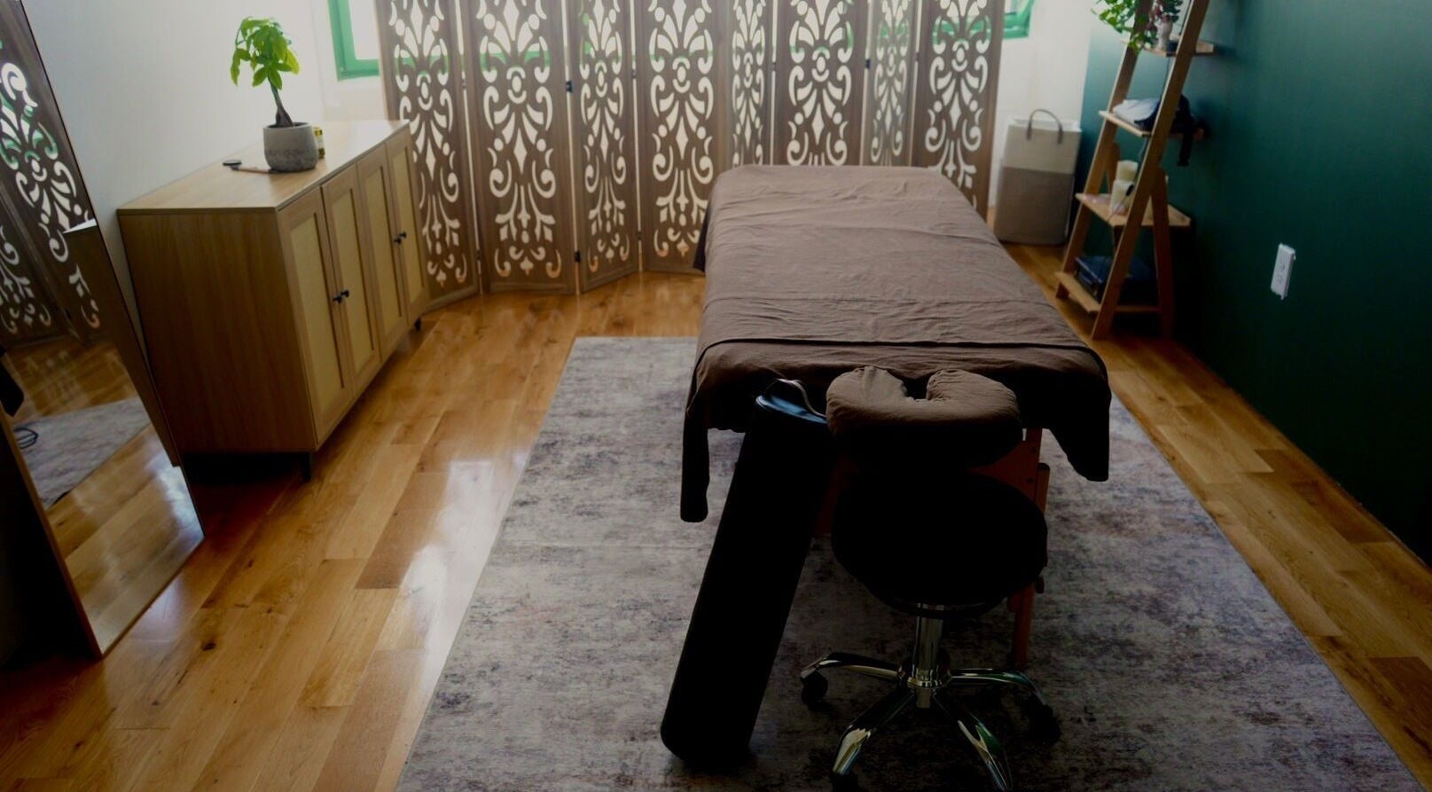 Tranquil massage room at A1A Massage in New York, New York, US, featuring a massage table and elegant decor.