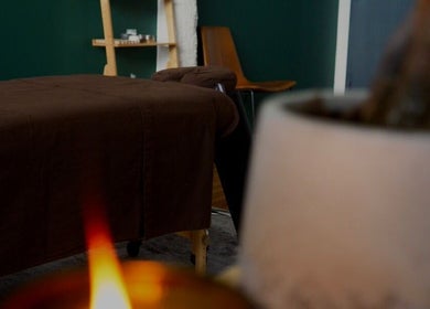 Tranquil massage room at A1A Massage, New York, New York, US, with a candlelit ambiance and cozy atmosphere.
