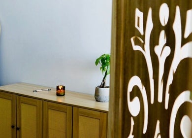 Tranquil interior of A1A Massage, New York, featuring a plant and candle.