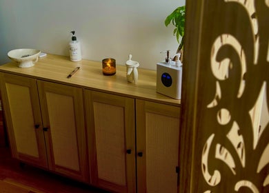 Elegant wooden cabinet with spa essentials at A1A Massage, New York, New York, US creating a calming ambiance.