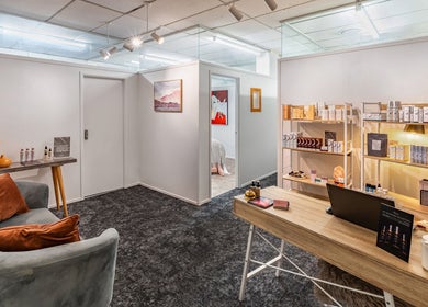 Inviting reception at Beauty Refinery, Auckland, NZ with cozy seating and elegant product displays.