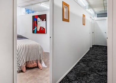 Relaxing treatment room at Beauty Refinery, Auckland, NZ with modern art and cozy decor.