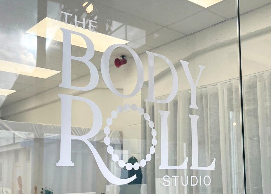 Entry to The Body Roll Studio in Auckland, Auckland, NZ with stylish glass door and minimalist decor.