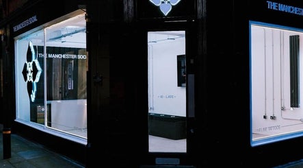 HERA X MANCHESTER SOCIAL storefront at Manchester, England, GB, featuring illuminated modern design.