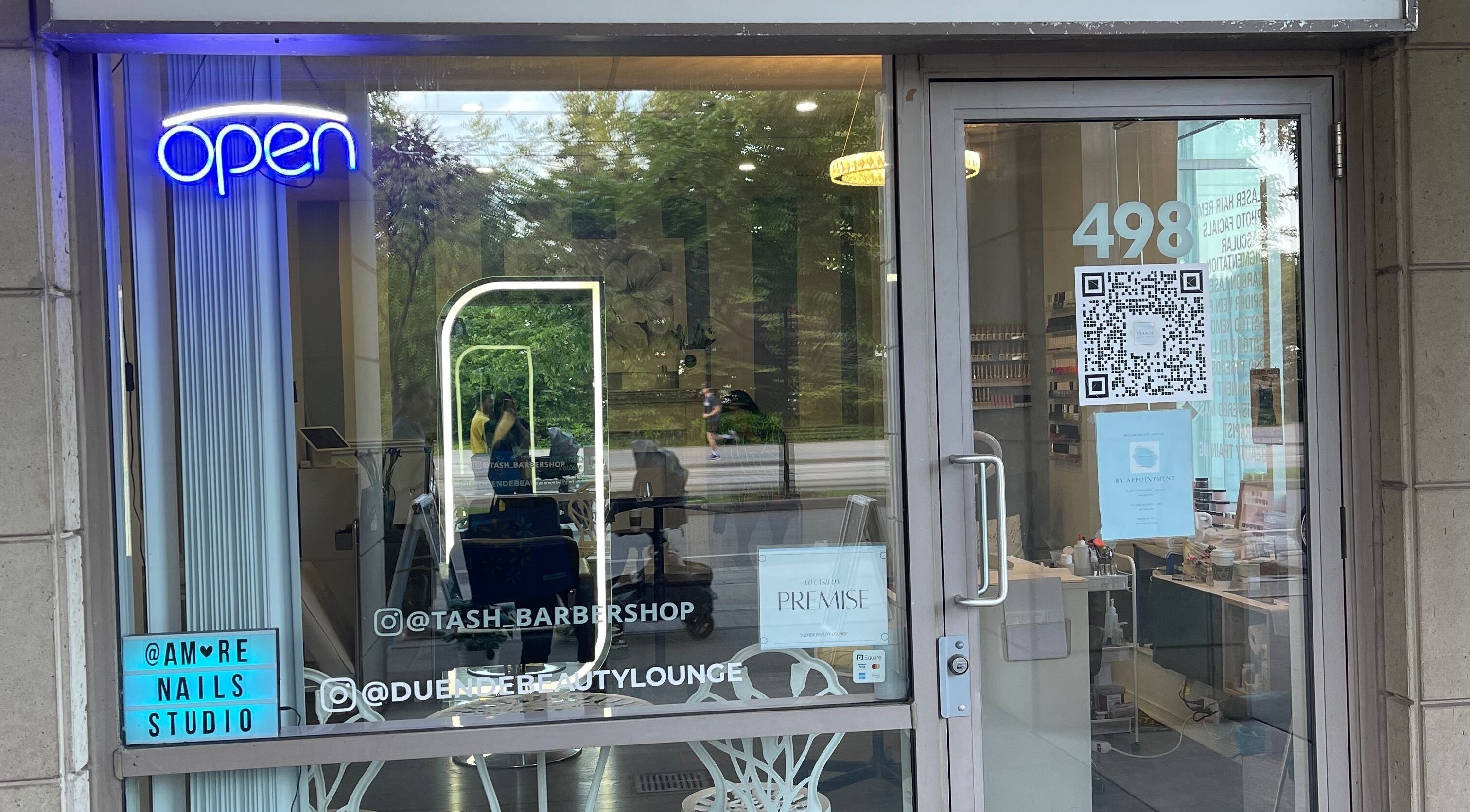 Front view of The Derma Laser Bar entrance in Toronto, Ontario, CA, showcasing its inviting open sign and modern decor.