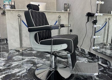 Modern barber chair at A Club Barbers, Dubai, Dubai, AE, reflecting luxury and style in a chic setting.