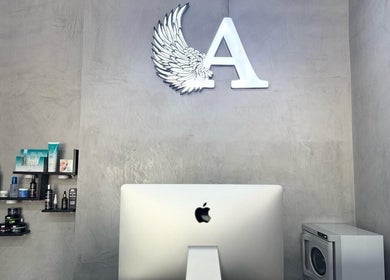 Modern reception at A Club Barbers, Dubai, Dubai, AE, with products on display and stylish decor.