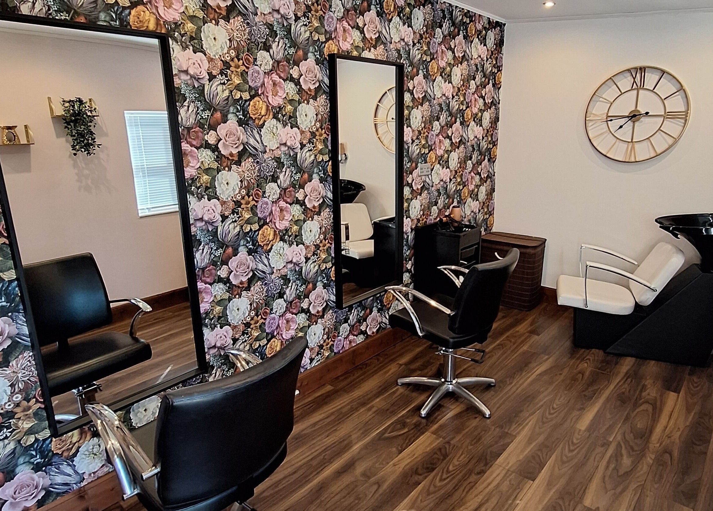 Elegant salon interior at Boujee_Barnet, Ayr, Scotland, with floral decor and chic styling chairs.