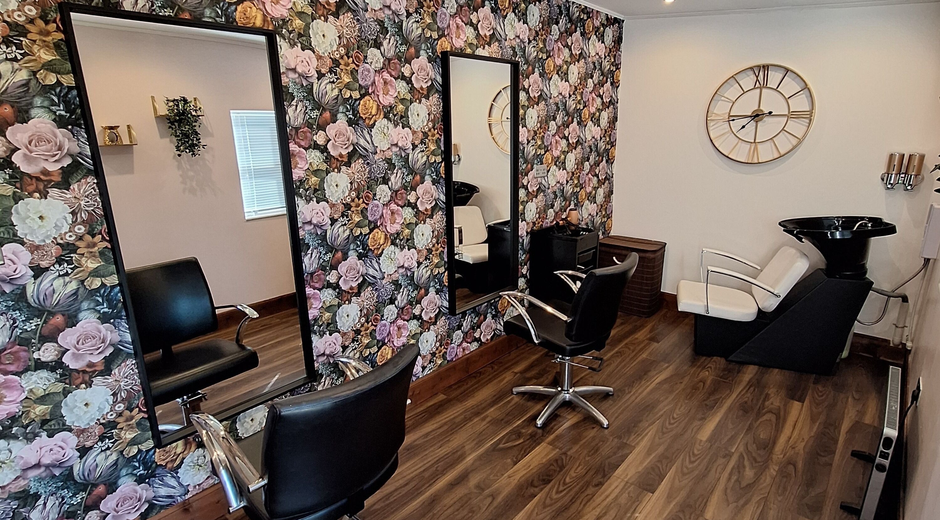 Elegant salon interior at Boujee_Barnet, Ayr, Scotland, with floral decor and chic styling chairs.
