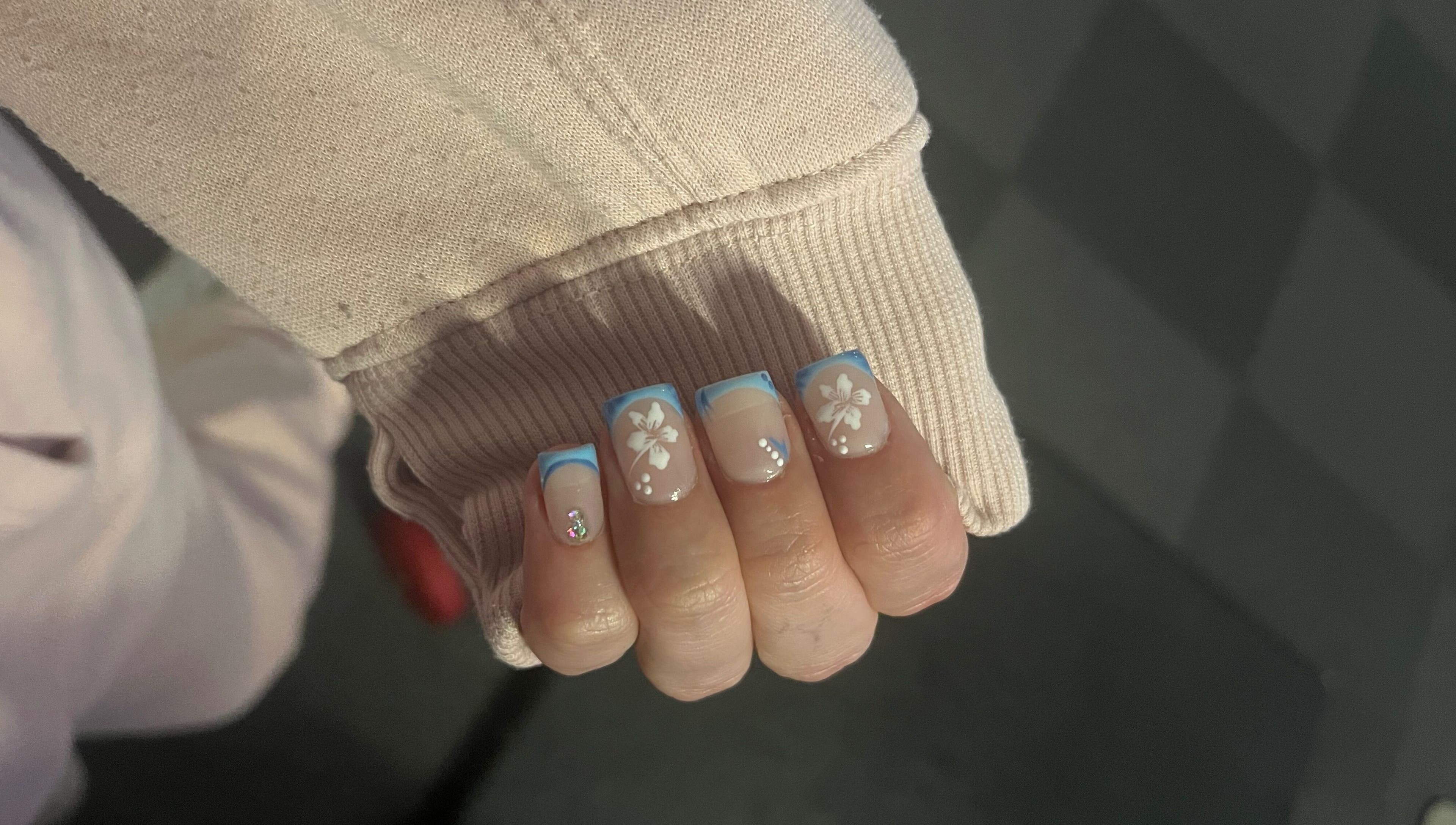Stylish nails with blue floral design at Glam Bar Ampthill, Ampthill, England, GB. Perfect for a chic look.