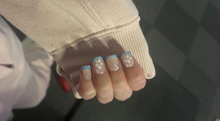 Stylish nails with blue floral design at Glam Bar Ampthill, Ampthill, England, GB. Perfect for a chic look.