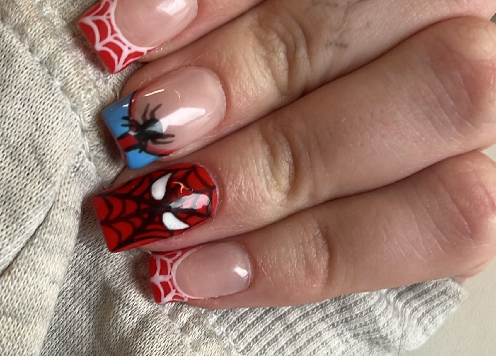 Intricate Spiderman-themed nail art, expertly done at Glam Bar Ampthill, Ampthill, England, GB.