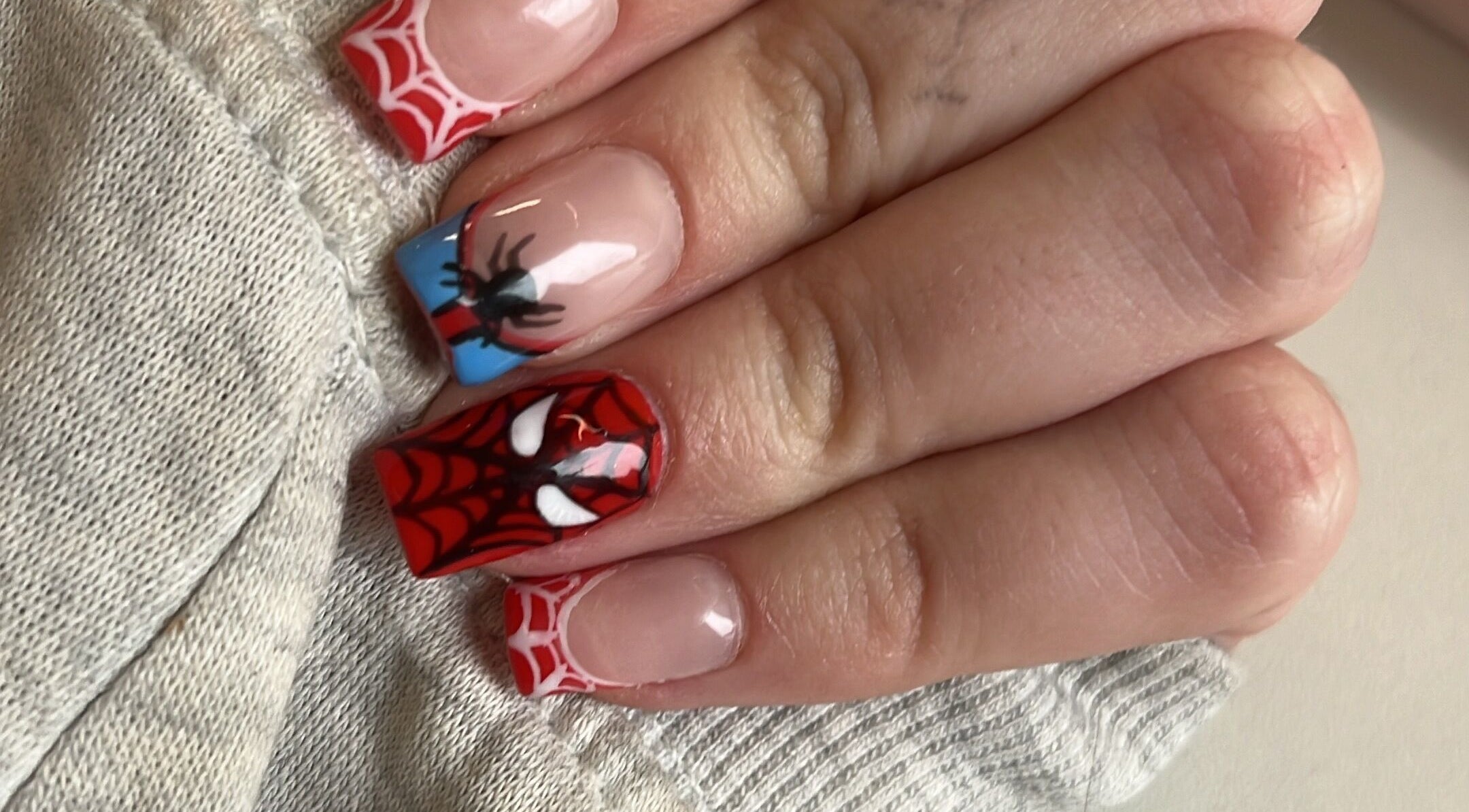 Intricate Spiderman-themed nail art, expertly done at Glam Bar Ampthill, Ampthill, England, GB.