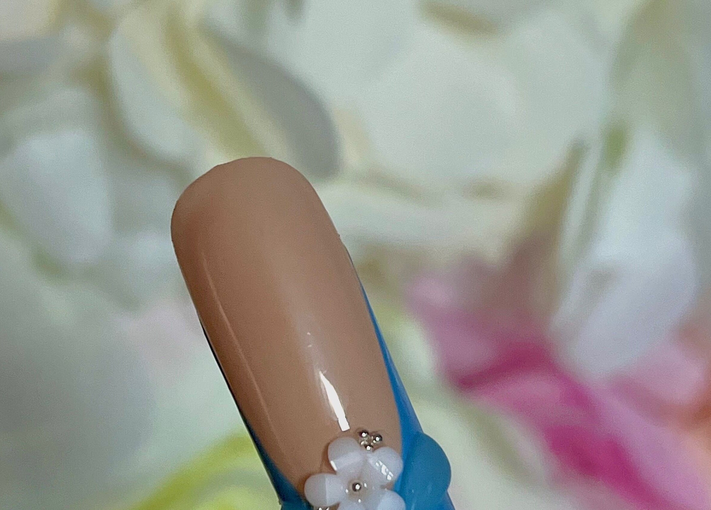 Close-up of a floral nail design at Glam Bar Ampthill, Ampthill, England, GB.
