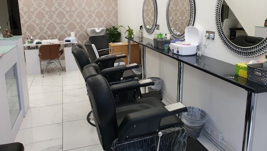 Stylish salon interior at Amrita's hair and beauty, London, England, GB with sleek chairs and modern mirrors.