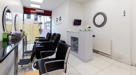 Chic salon interior at Amrita's hair and beauty in London, England, GB with sleek mirrors and stylish seating.