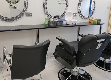 Modern salon chairs at Amrita's hair and beauty, London, England, GB, showcasing sleek salon design.