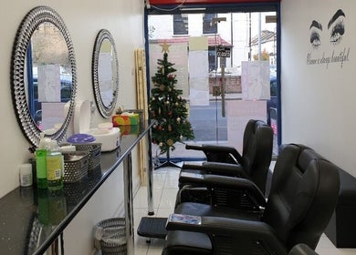 Chic interior of Amrita's Hair and Beauty, decorated with mirrors and holiday decor, in London, England, GB.