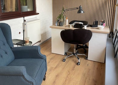 Elegant salon workspace at By Jade Emily in Newport, England, GB, featuring a plush chair and modern desk.