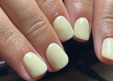 Close-up of lemon-hued nails polished at By Jade Emily, located in Newport, England, GB.