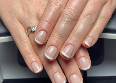 Stylish French manicure at By Jade Emily, Newport, England, GB. Featuring pristine white tips and glossy finish.