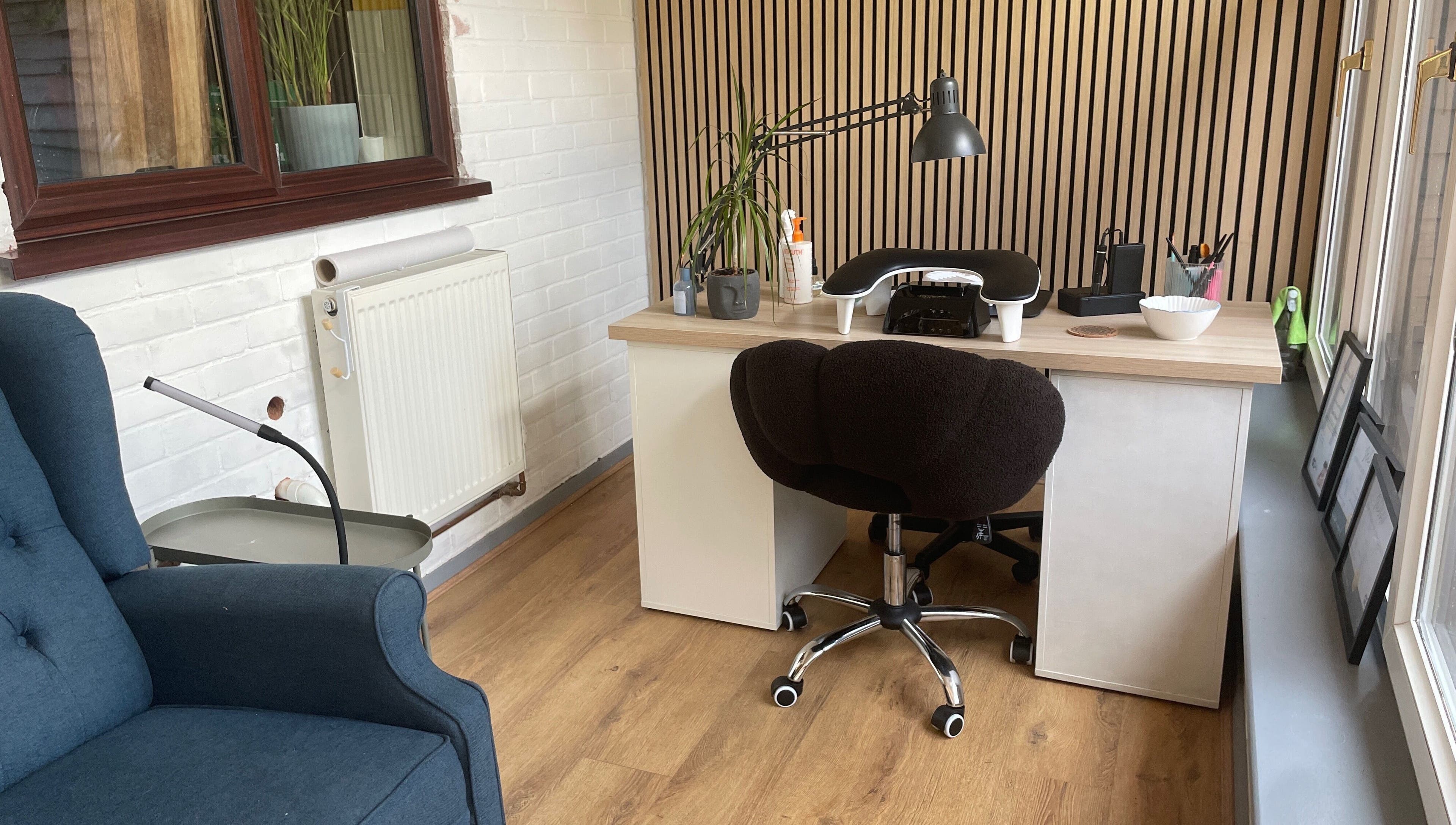 Inviting beauty desk at By Jade Emily, Newport, England, GB, featuring a cozy chair and decor.