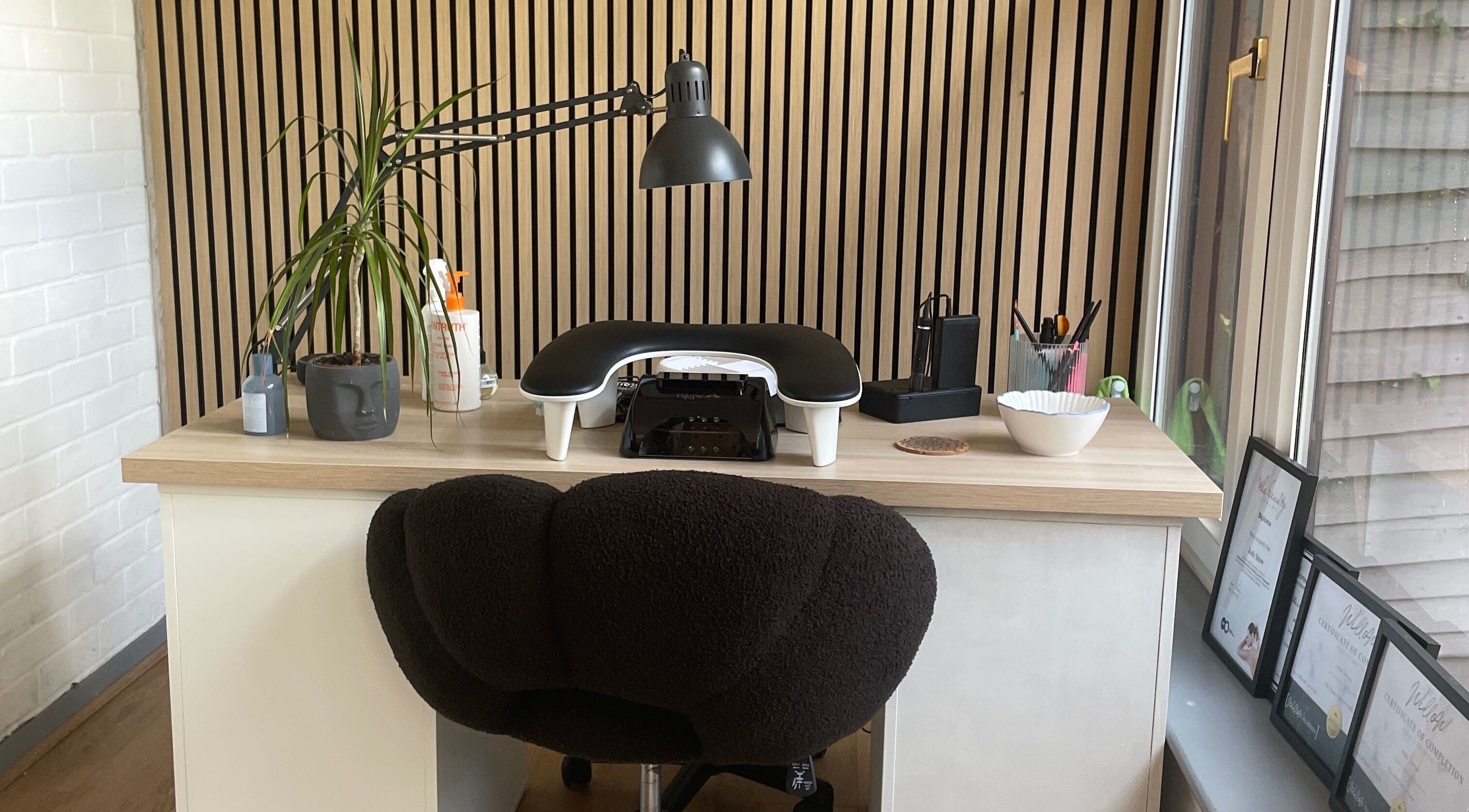 Stylish nail station at By Jade Emily, Newport, England, GB, featuring sleek design and ambient lighting.