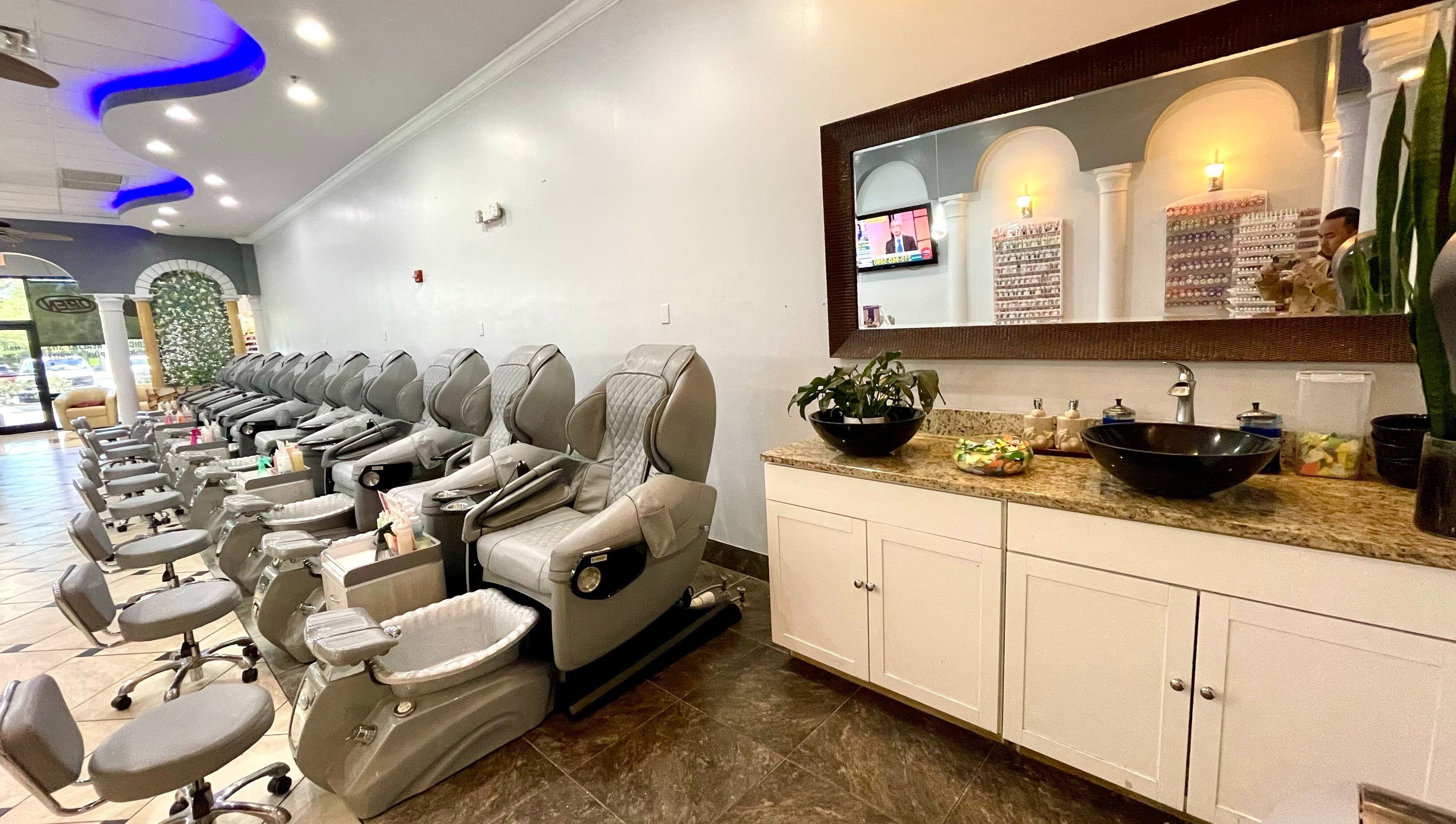 Pedicure chairs line the serene interior of Aladdin Nails & Spa in Ocoee, Florida, US, offering a relaxing experience.