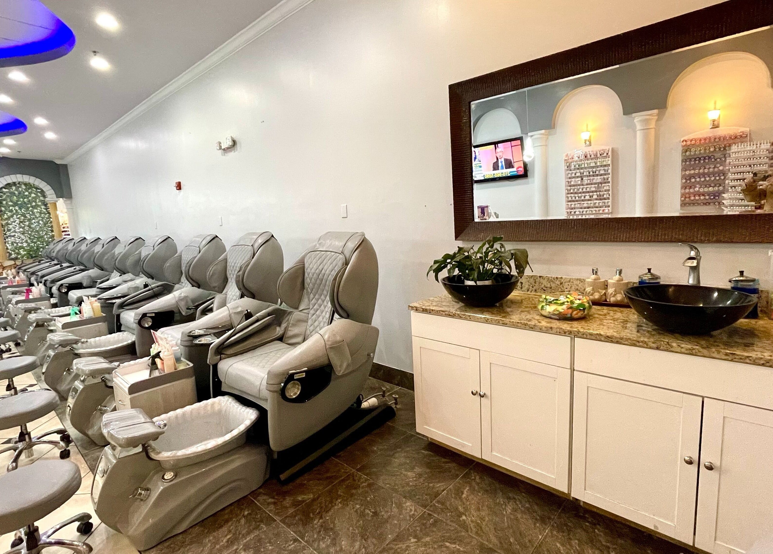Pedicure chairs line the serene interior of Aladdin Nails & Spa in Ocoee, Florida, US, offering a relaxing experience.
