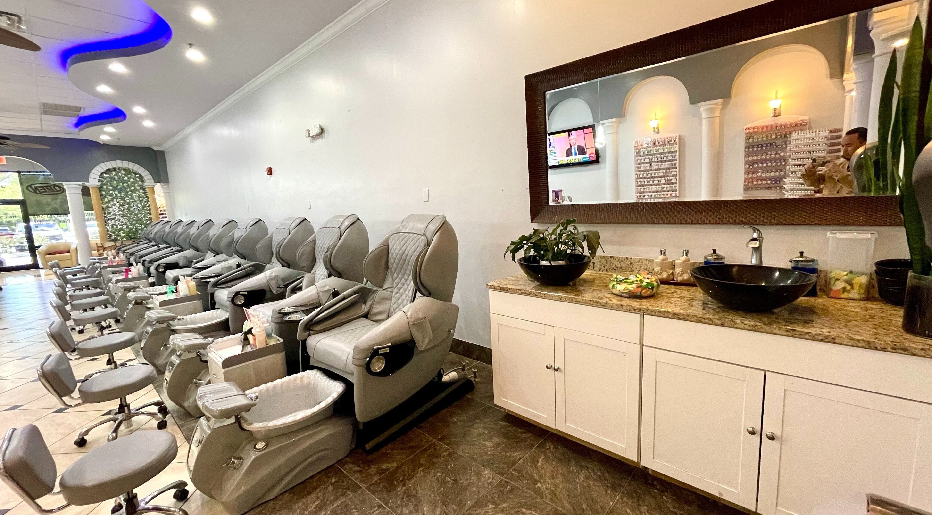 Pedicure chairs line the serene interior of Aladdin Nails & Spa in Ocoee, Florida, US, offering a relaxing experience.