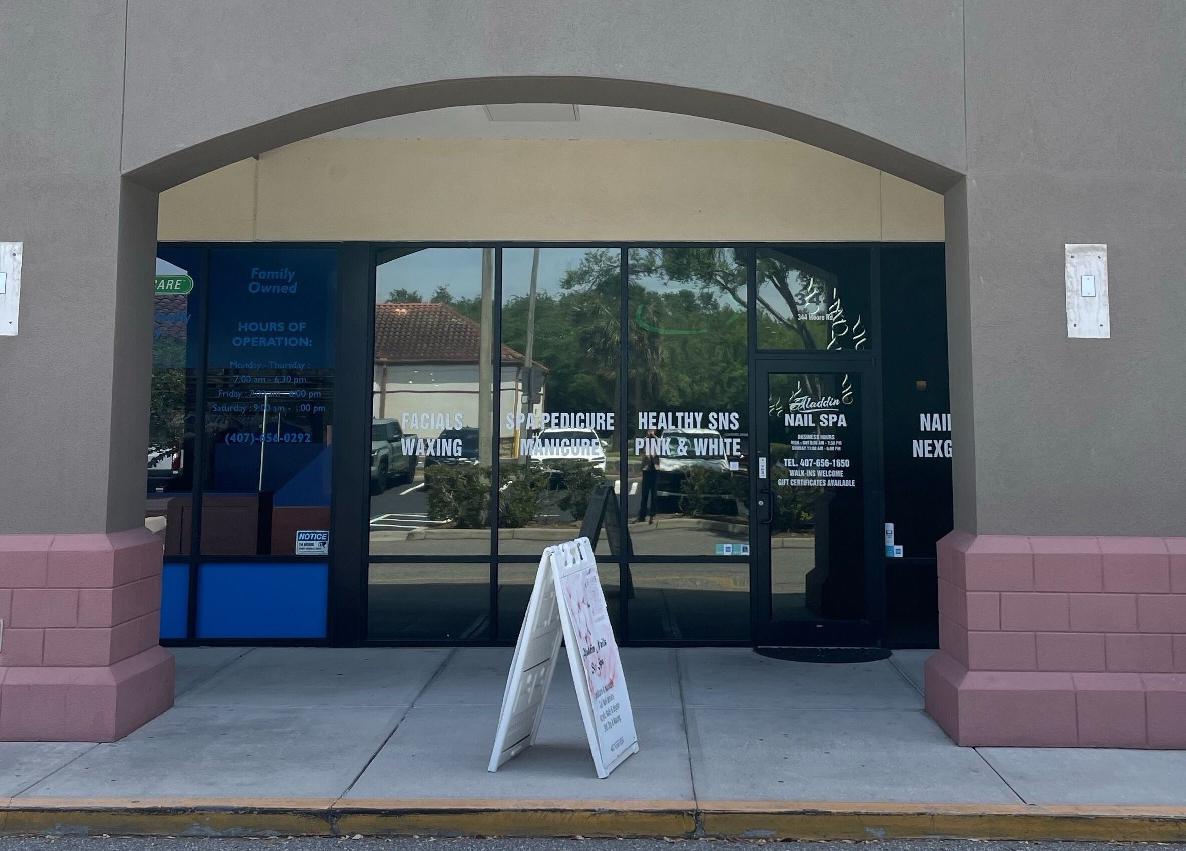 Entrance of Aladdin Nails & Spa in Ocoee, Florida, US, featuring welcoming exterior design.