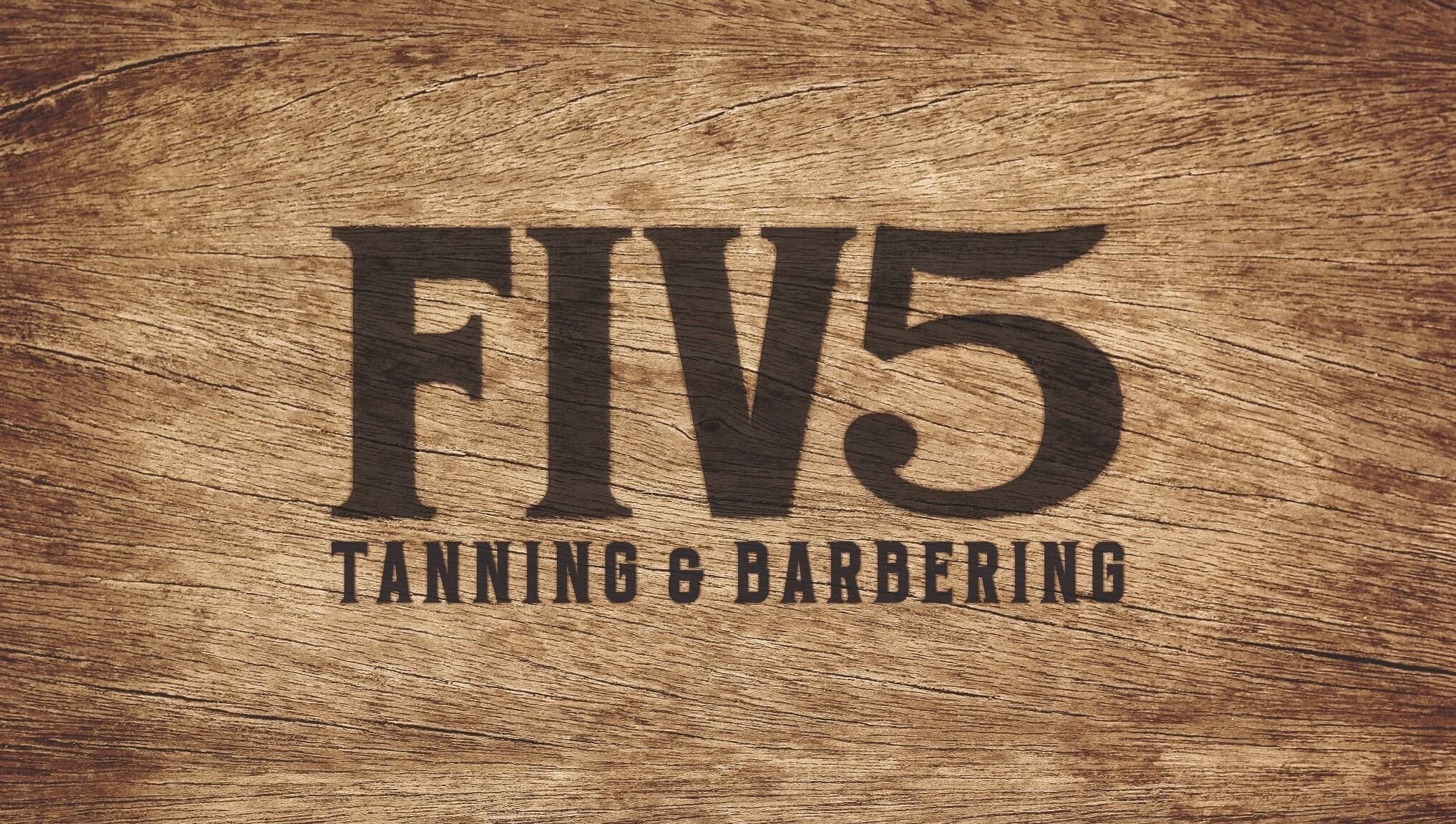 FIV5 Tanning & Barbering logo on wood texture, Sandy, England, GB.