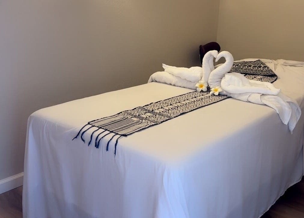 Luxurious massage table setup with towel swans at Las Vegas's Luxurious Expert in Relaxation, Las Vegas, Nevada, US.