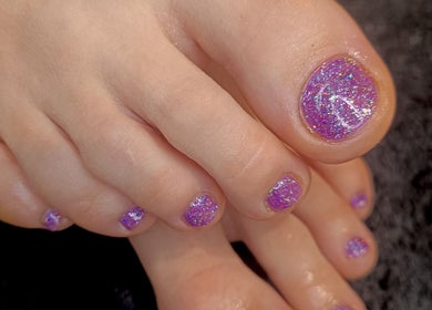 Purple glitter pedicure at Your Nail World, Haarlem, NL showcasing elegant foot care service.