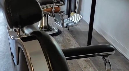 Modern barber chair at Cult Barbers, Coventry, England, GB, showcasing sleek design and comfort.