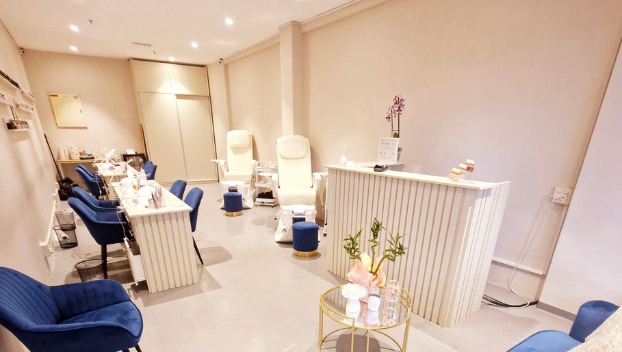 Elegant interior of Poise & Polish Beauty Bar in Cape Town, Western Cape, ZA, featuring plush chairs and manicure stations.