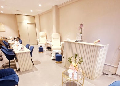Elegant interior of Poise & Polish Beauty Bar in Cape Town, Western Cape, ZA, featuring plush chairs and manicure stations.
