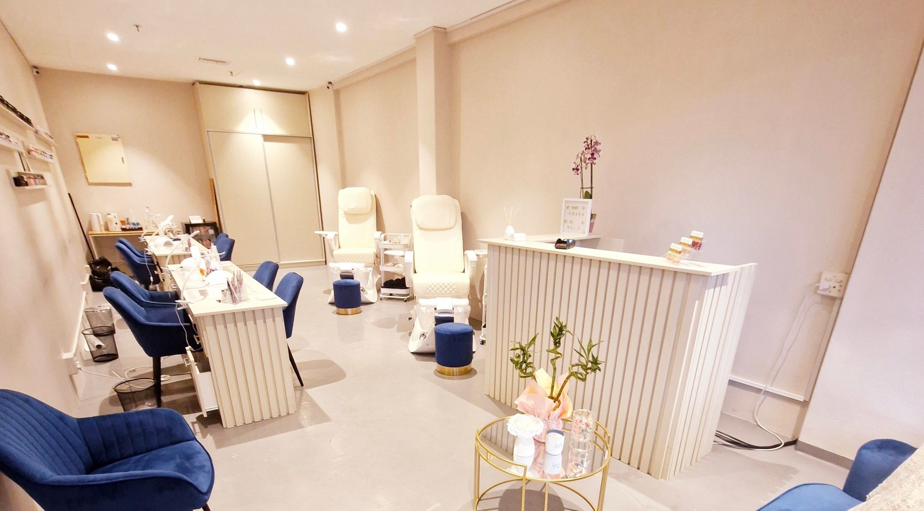 Elegant interior of Poise & Polish Beauty Bar in Cape Town, Western Cape, ZA, featuring plush chairs and manicure stations.