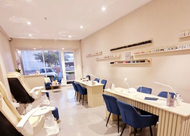 Interior view of Poise & Polish Beauty Bar in Cape Town, Western Cape, ZA showcasing manicure stations and pedicure chairs.