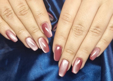 Elegant pink nails at Poise & Polish Beauty Bar, Cape Town, Western Cape, ZA on luxurious blue satin.