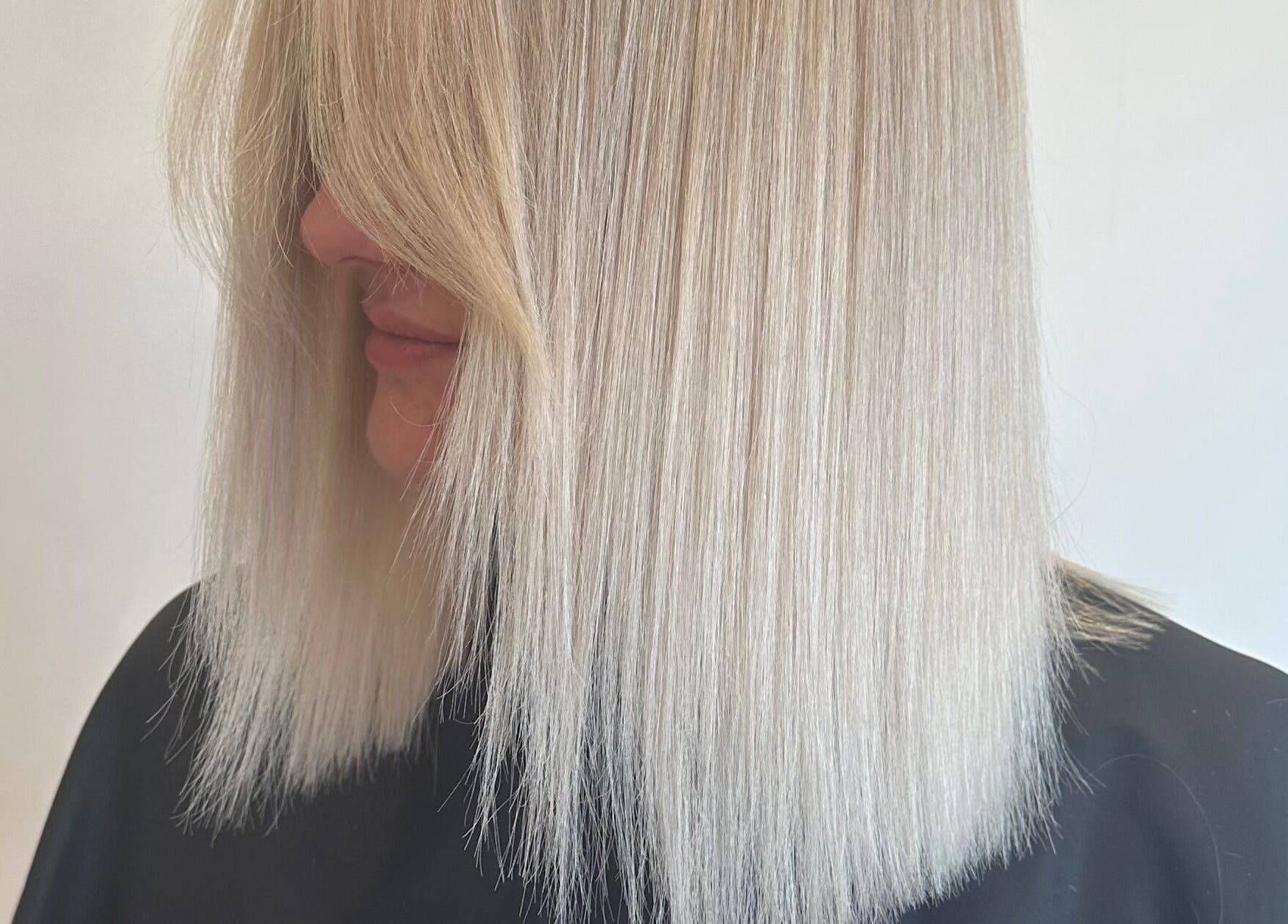 Sleek blonde hair styled at Hair By Eden Carruthers, Melbourne, Victoria, AU.
